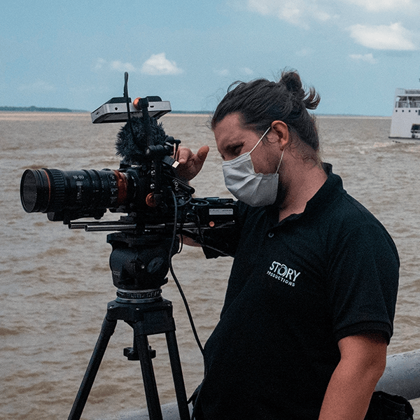 A camera operator films on location in a pier in Satarém, Belem