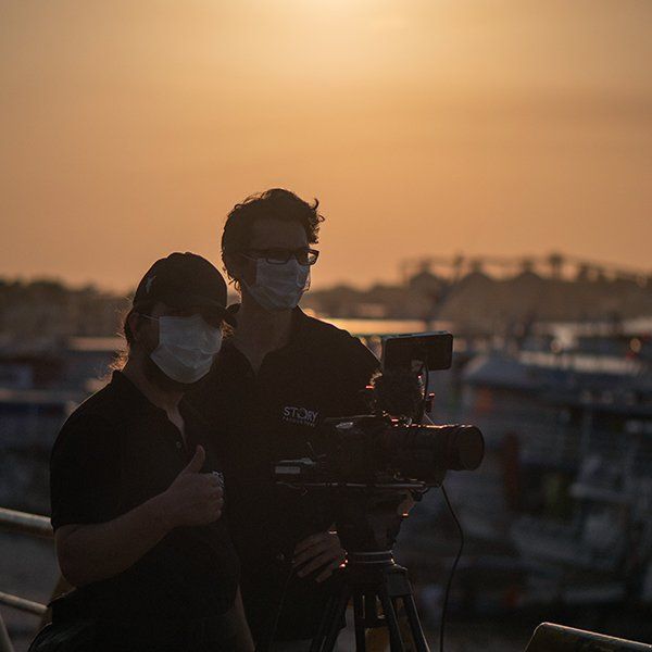 A camera operator  and the director frame a shot during filming