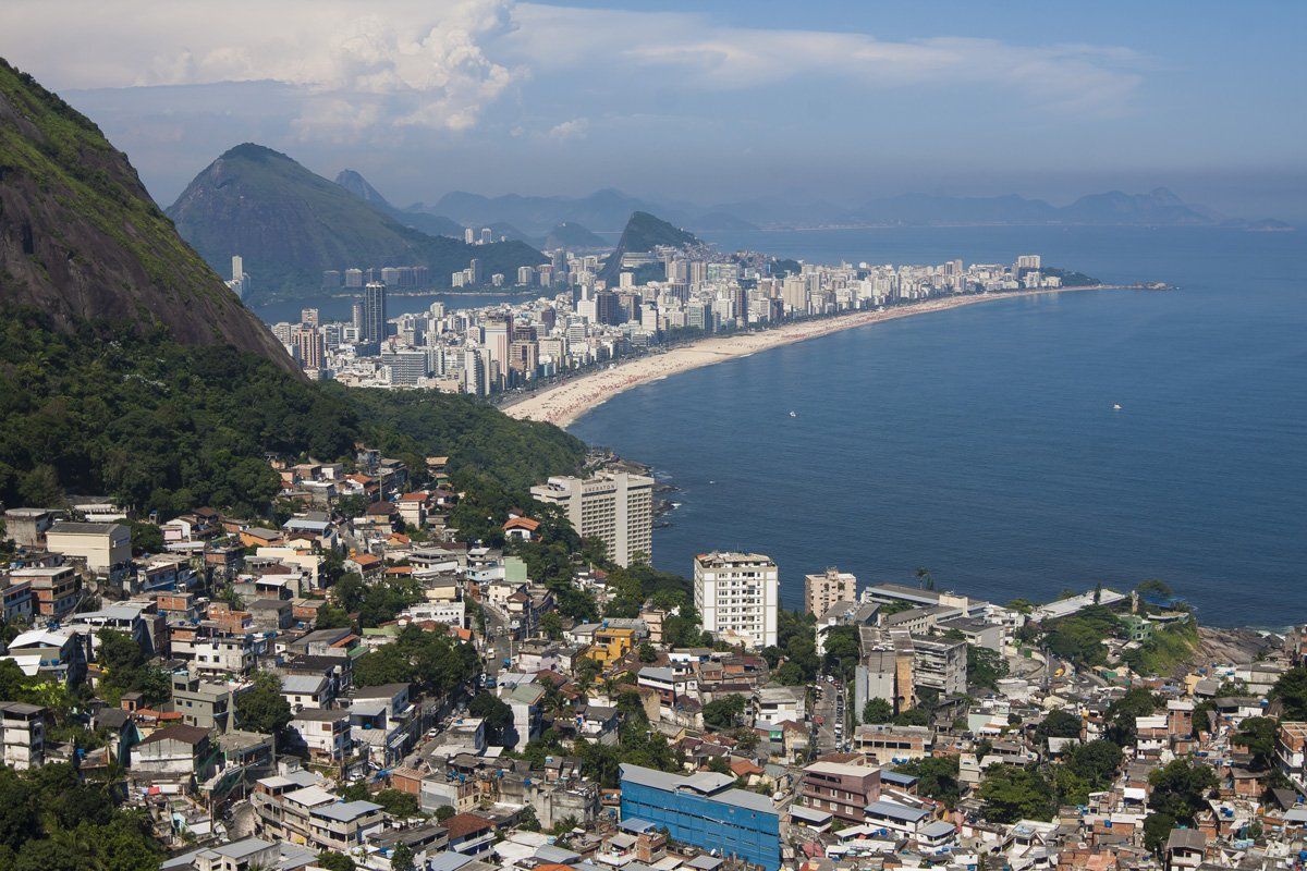 An aerial view of a city surrounded by water and mountains