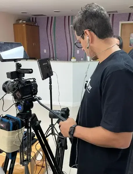 Story Productions camera man adjust a camera