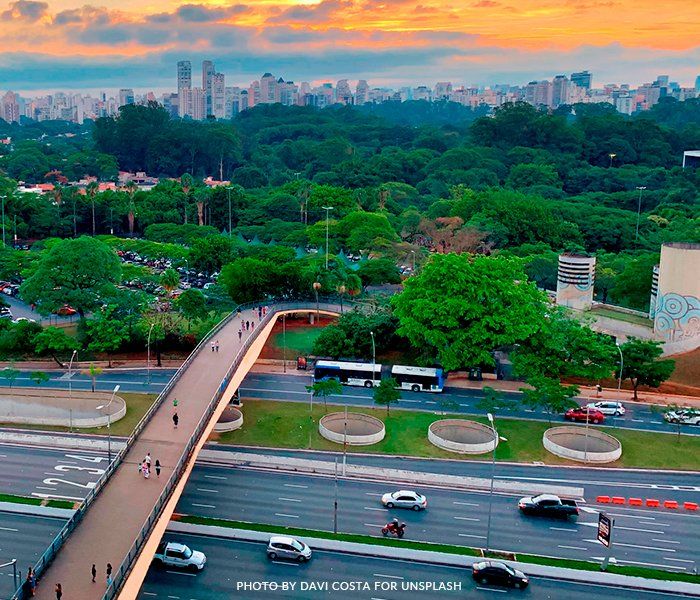 An aerial view of a bridge over a highway in a city