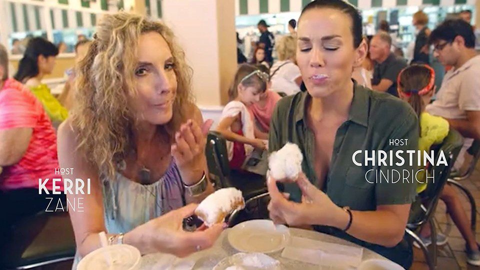 Kerri Zane and Christina Cindrich have a pastry treat in a crowded restaurant