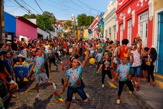 A group of dancers with small umbrellas on the streets of Olinda for Carnaval