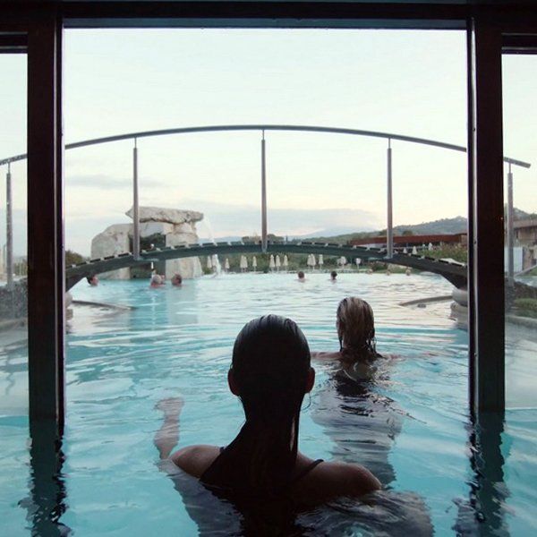 Christina Cindrich and Kerri Zane swim in a pool
