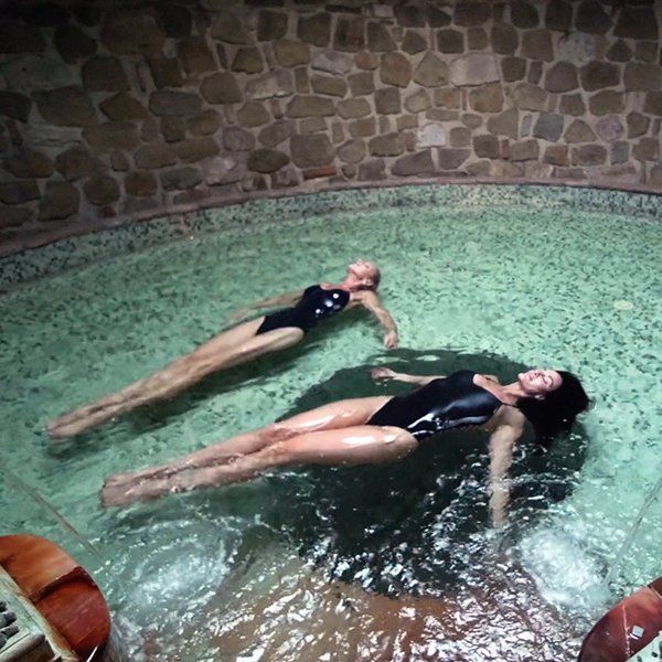 Kerri Zane and Christina Cindrich swim in an indoor pool