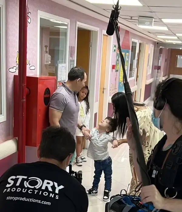 A man wearing a black shirt that says story productions