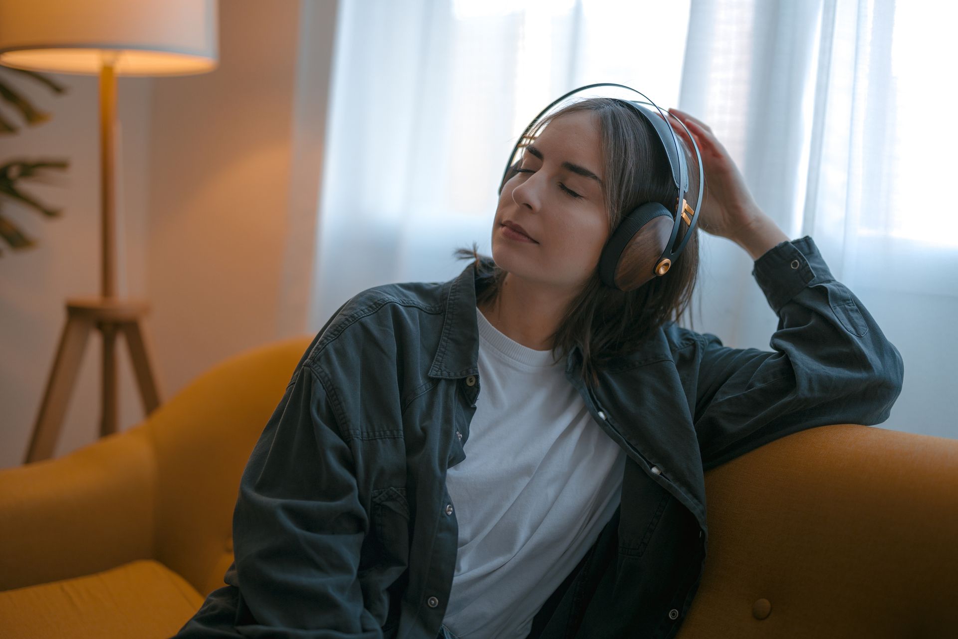 A woman is sitting on the grass stretching her legs.