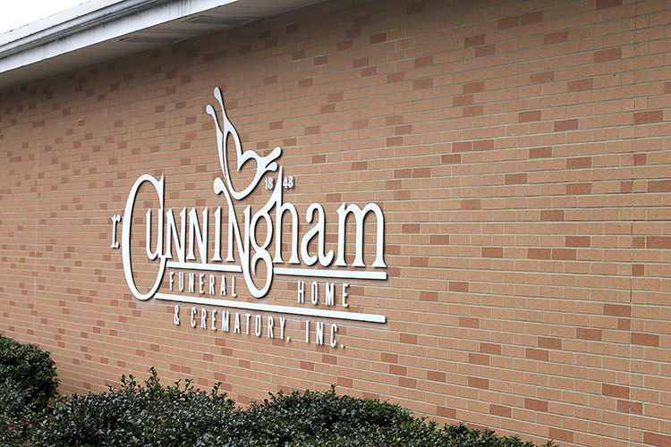 Sign for Cunningham Retirement Community on a brick building wall
