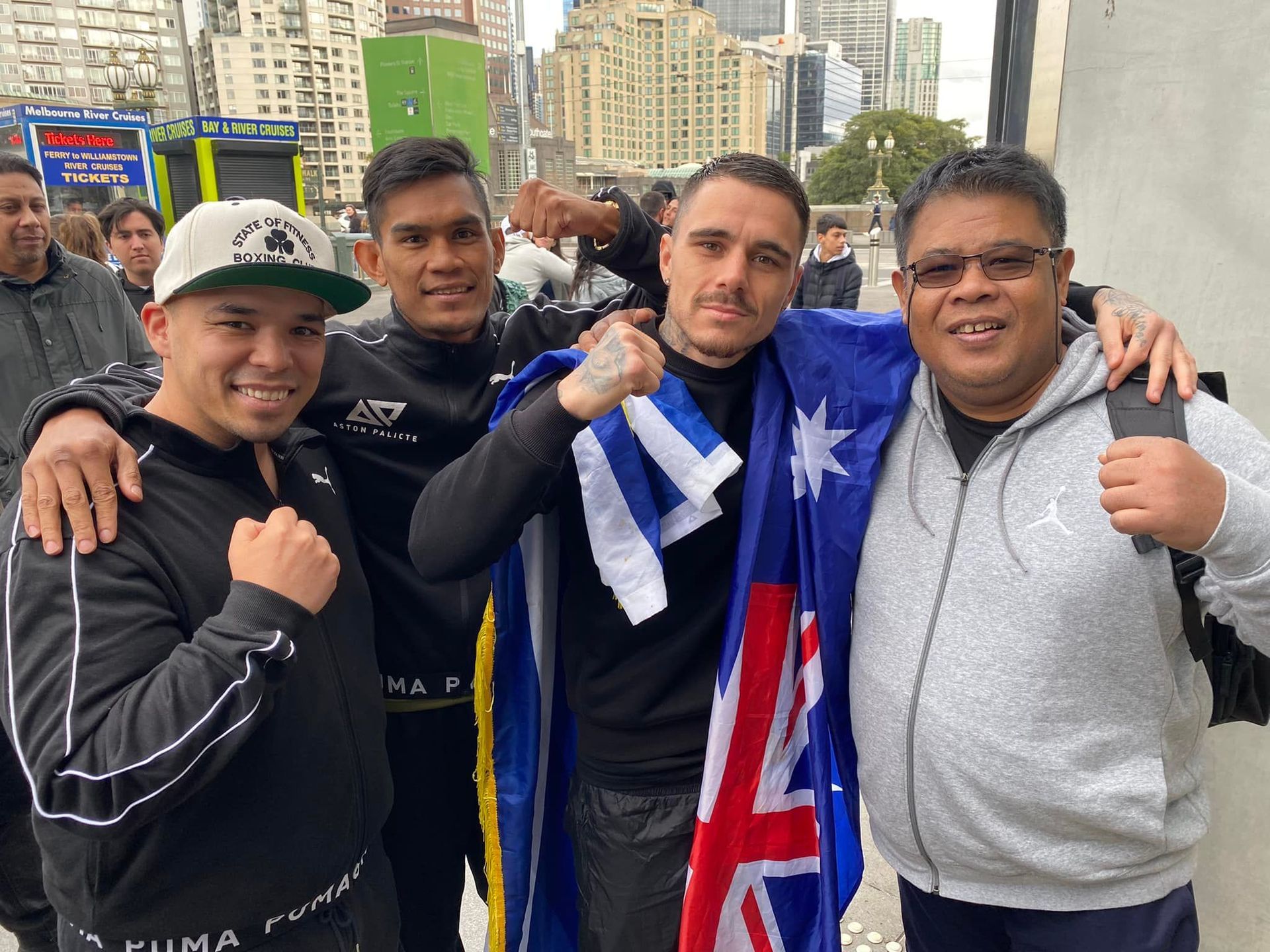A group of men are posing for a picture while holding flags.