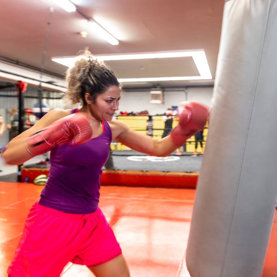 Female boxer working the heavy bag