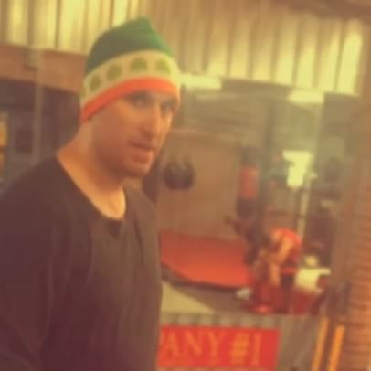 A man standing in front of a sign that says any 21