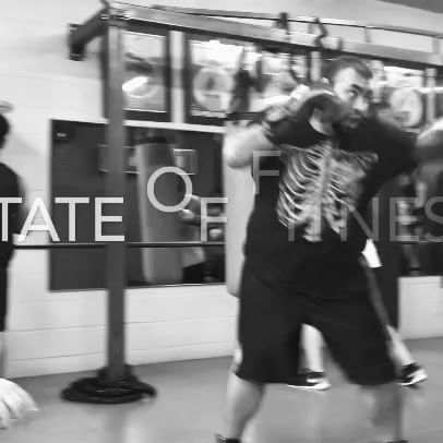 A man in a skeleton shirt is boxing in a gym