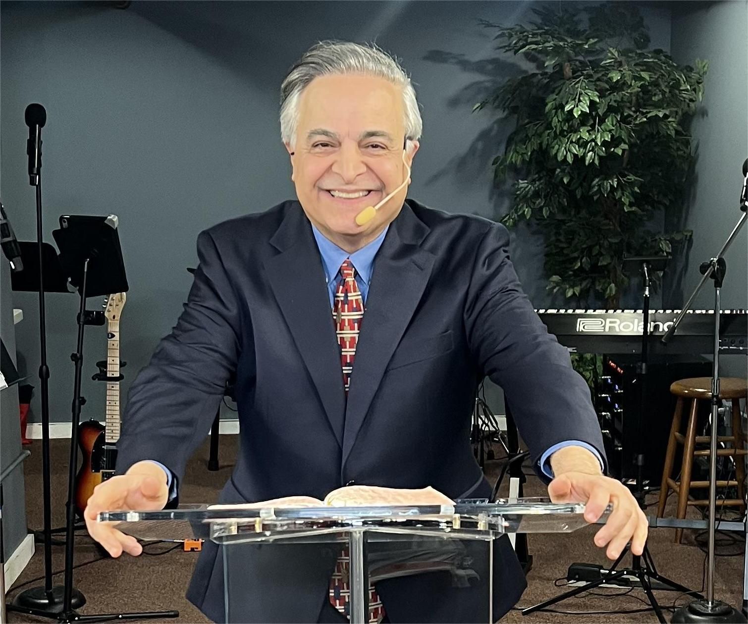 People shaking hands and smiling indoors.