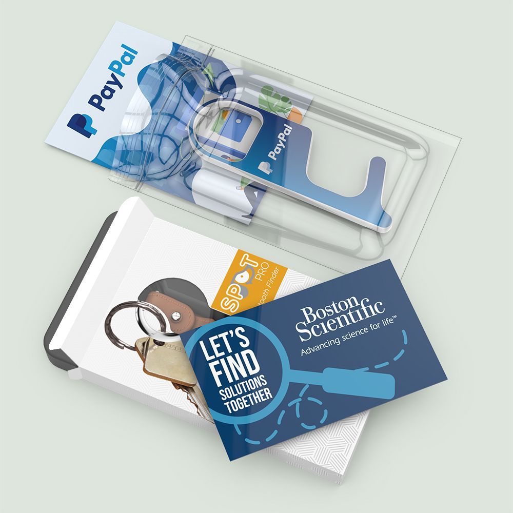 A paypal card and a business card are sitting on top of each other on a table.