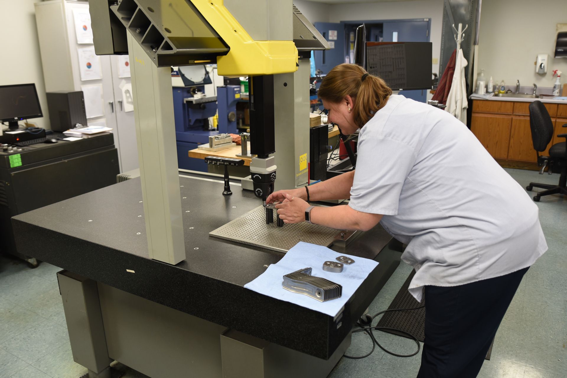A woman is working on a machine in a lab