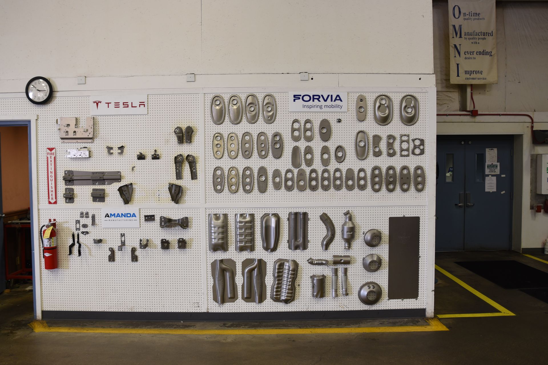 A wall with a lot of tools on it and a fire extinguisher