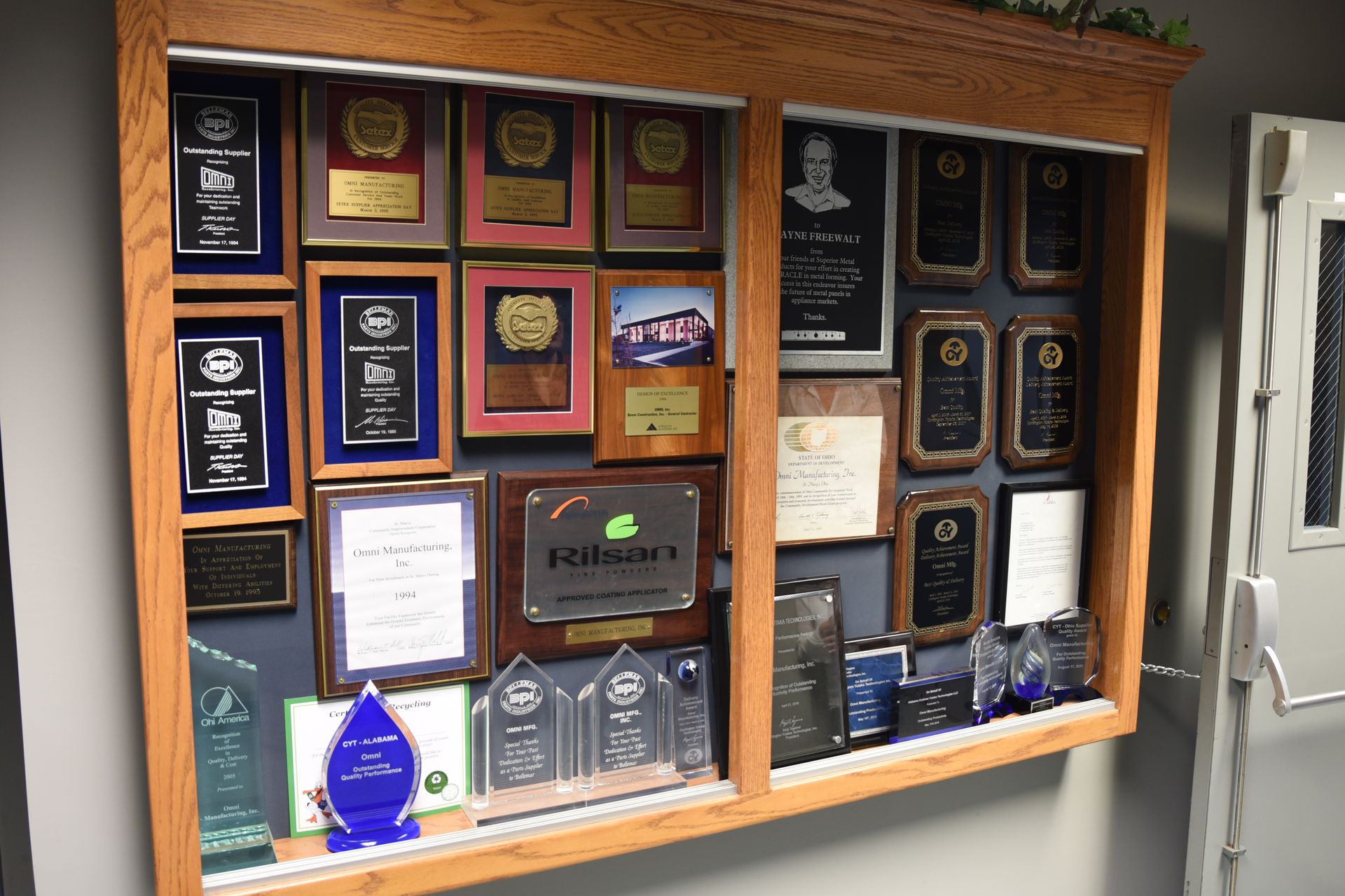 A display case filled with trophies and plaques including one that says terrace