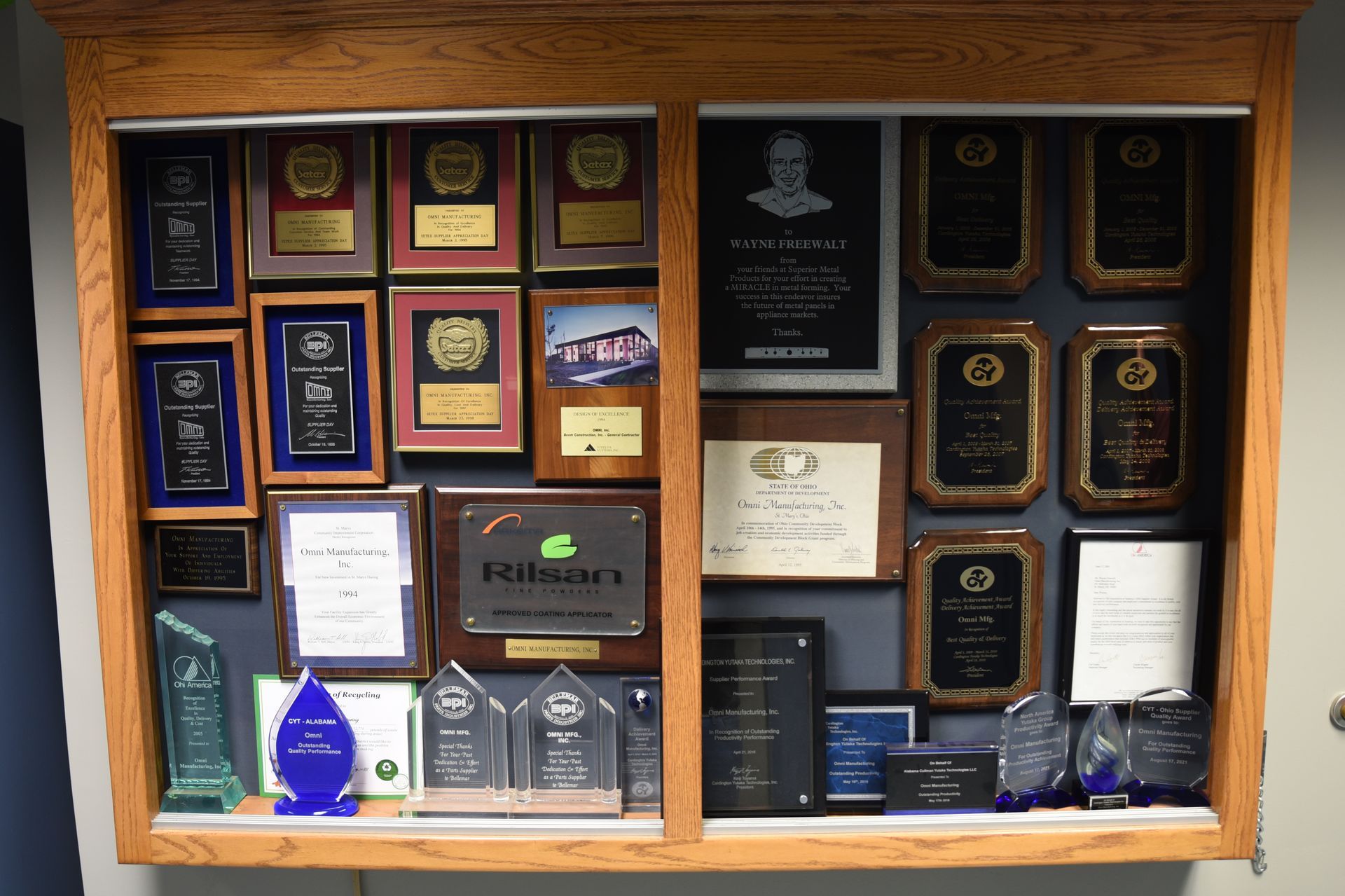 A display case full of trophies and plaques including one that says federal