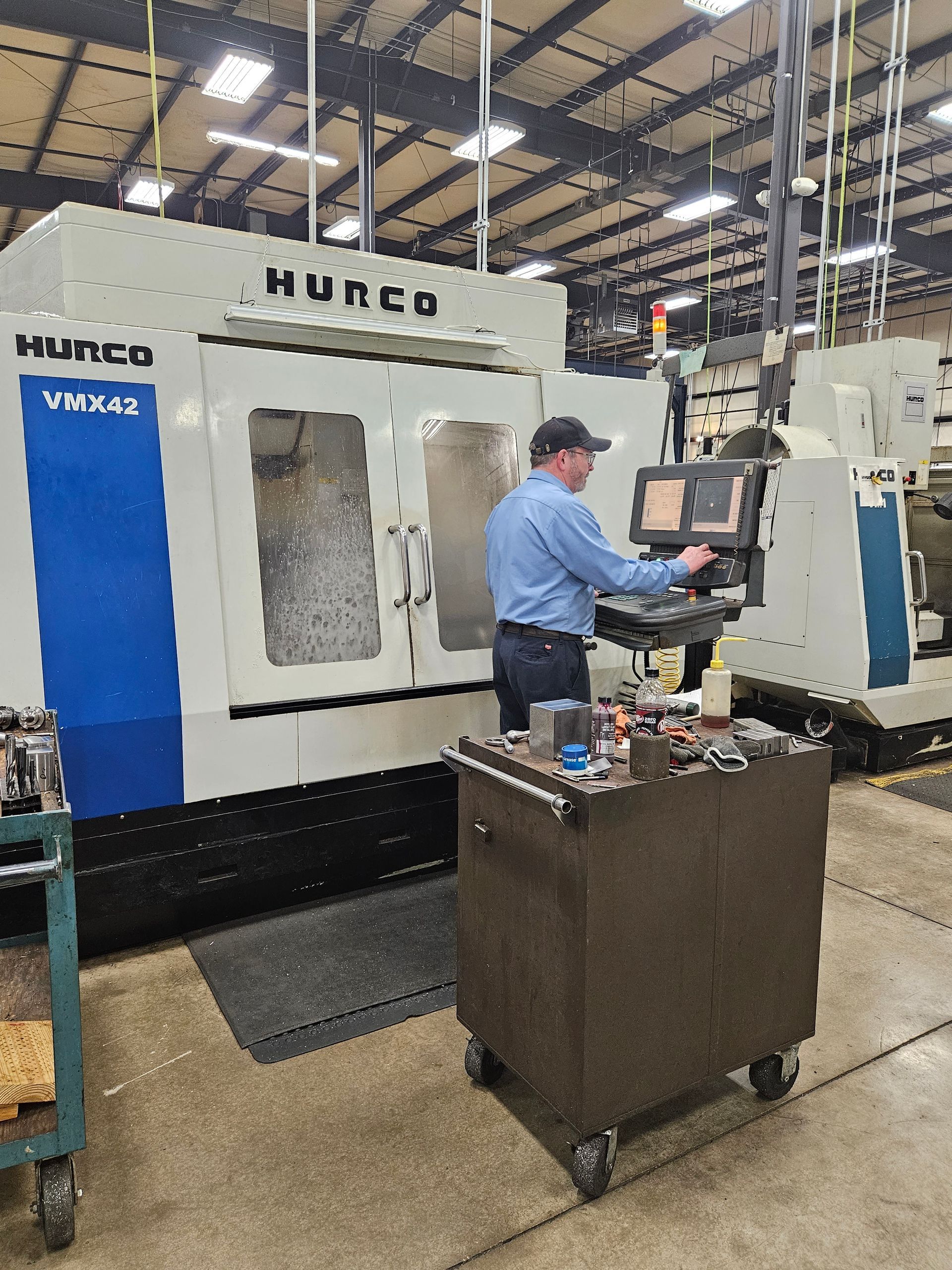 A man is working on a machine in a factory.