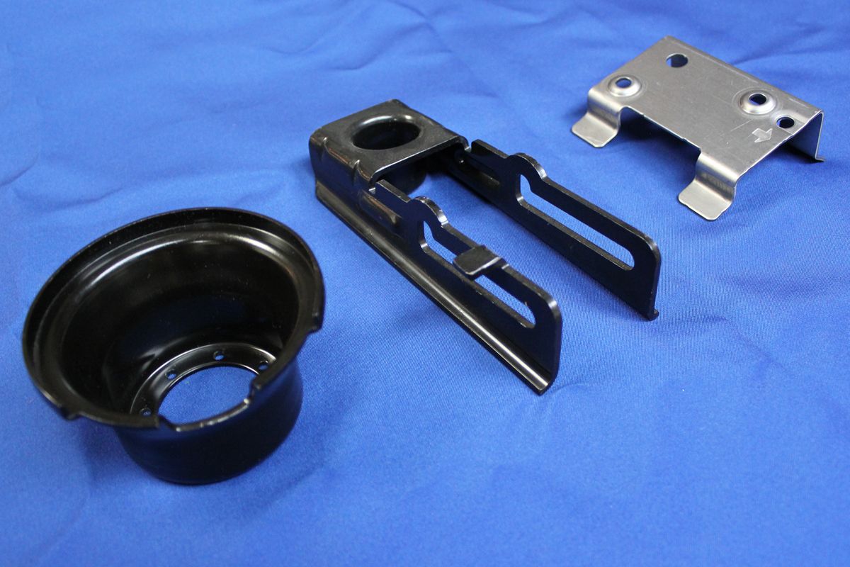 A few metal pieces are laying on a blue cloth