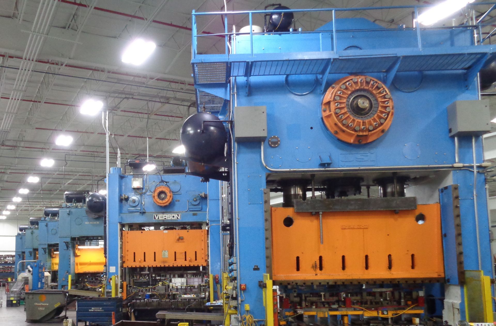 A blue and orange machine in a factory with the word utoh on it
