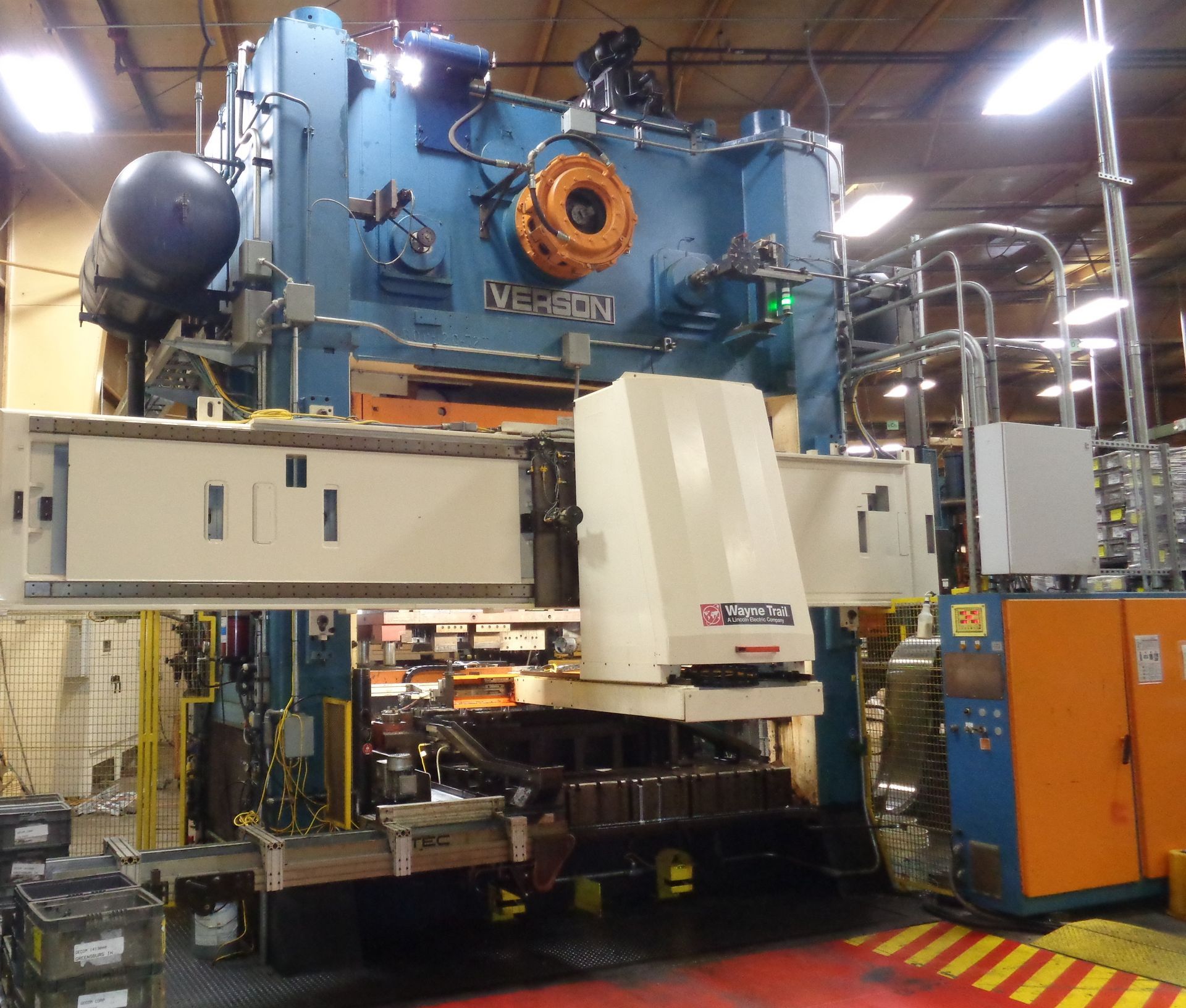 A large machine in a factory has the word wesson on it