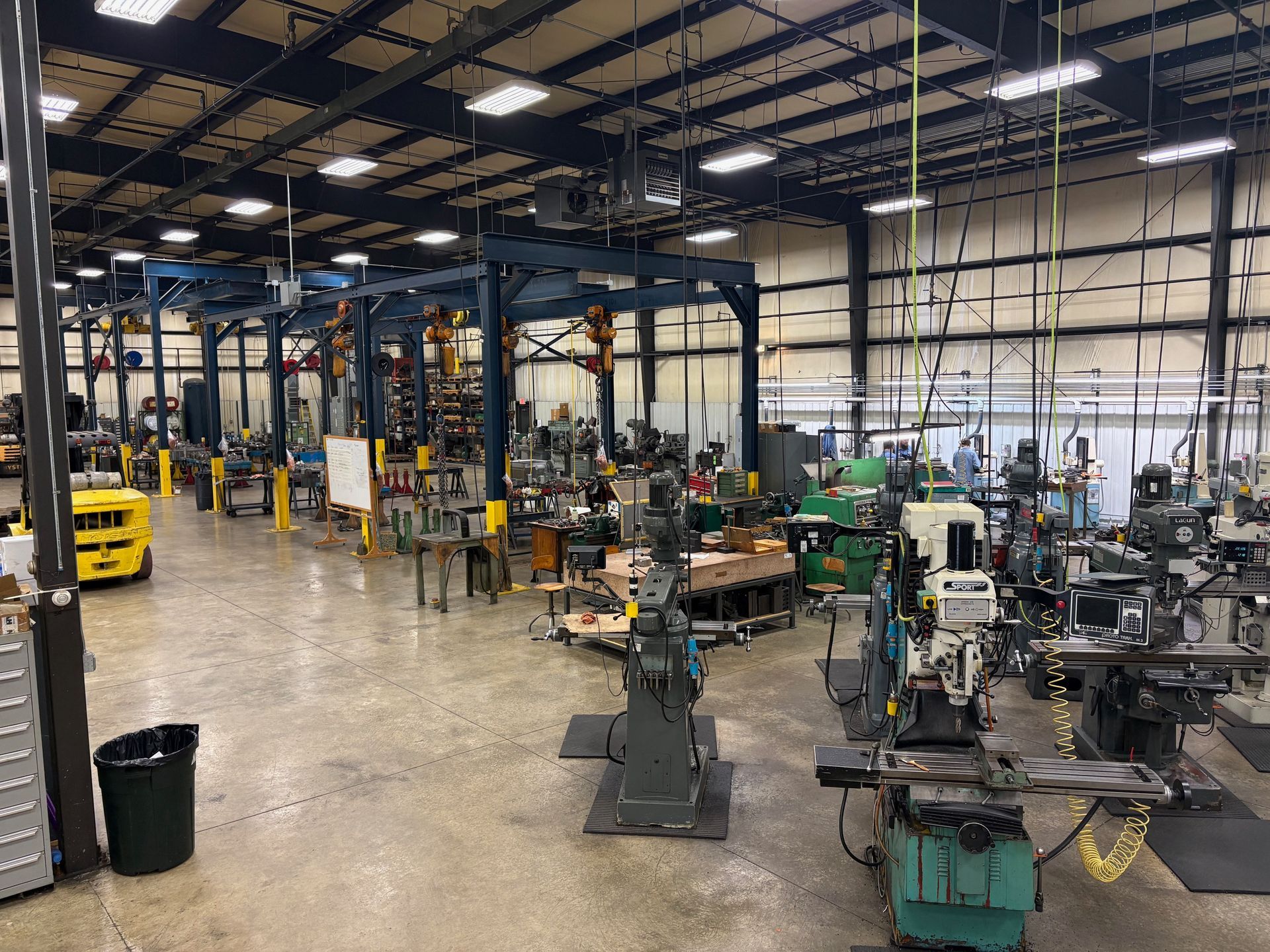 A woman is working on a machine in a lab