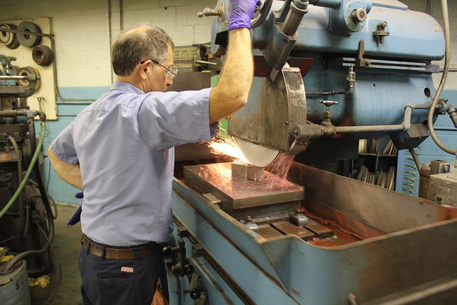 A man is working on a machine in a factory.