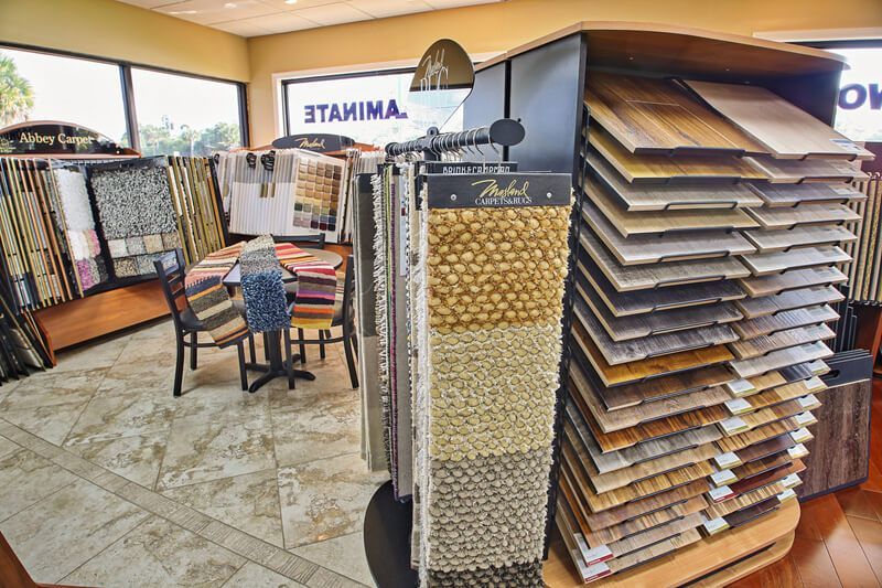 A showroom filled with lots of different types of flooring and carpets.