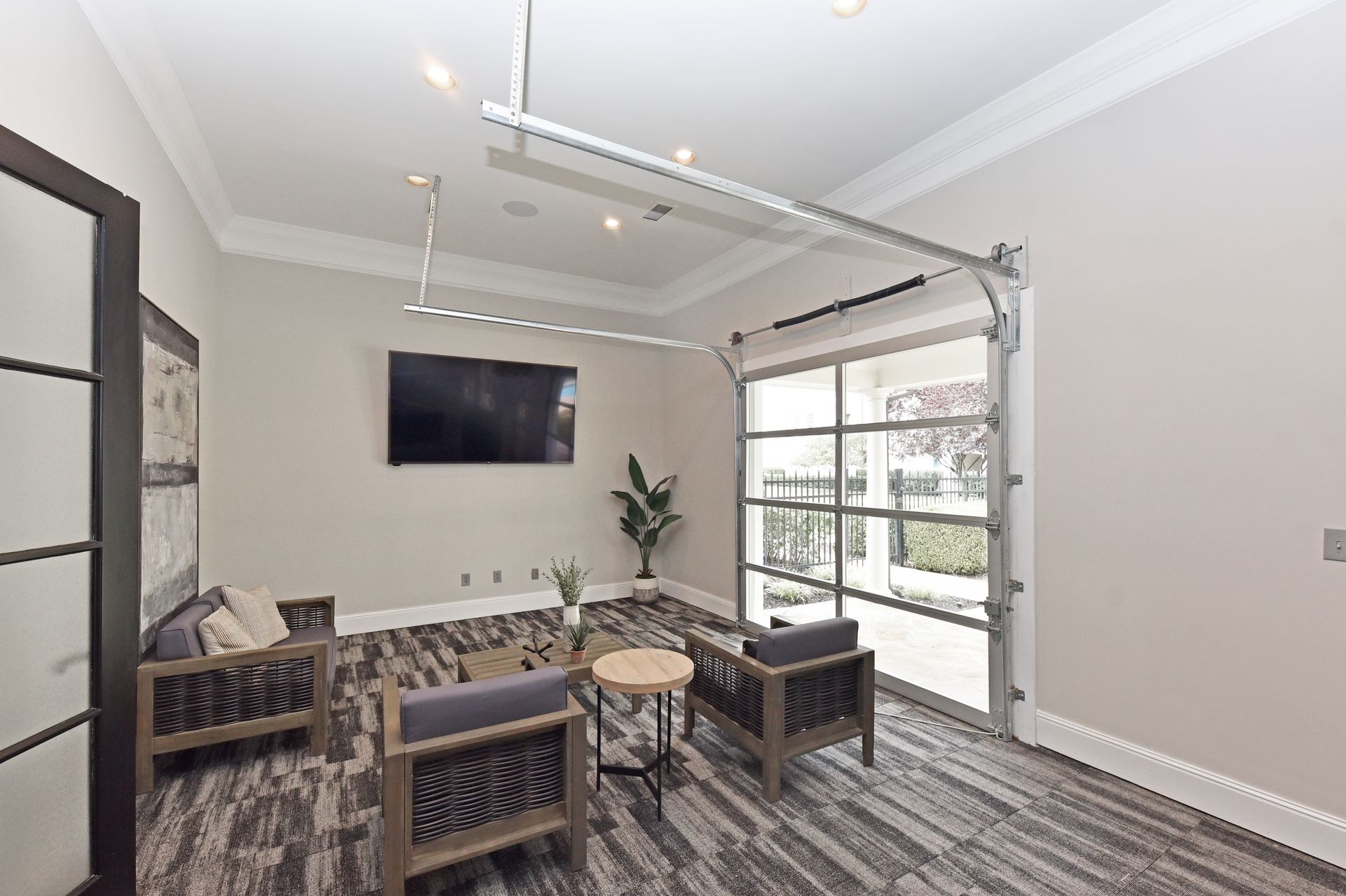 A garage door-style window, two chairs, and a television.