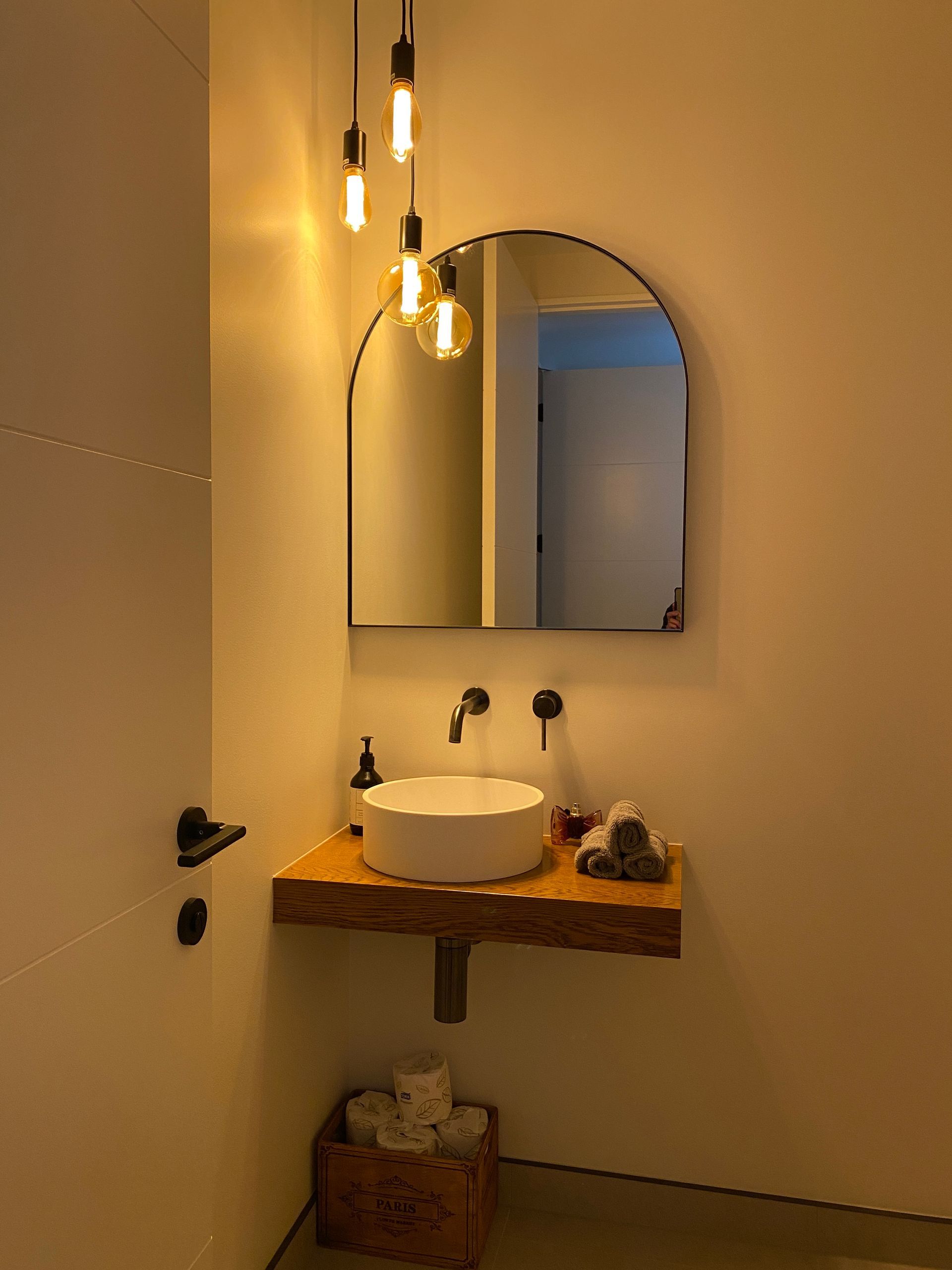 A bathroom with a sink and a mirror on the wall