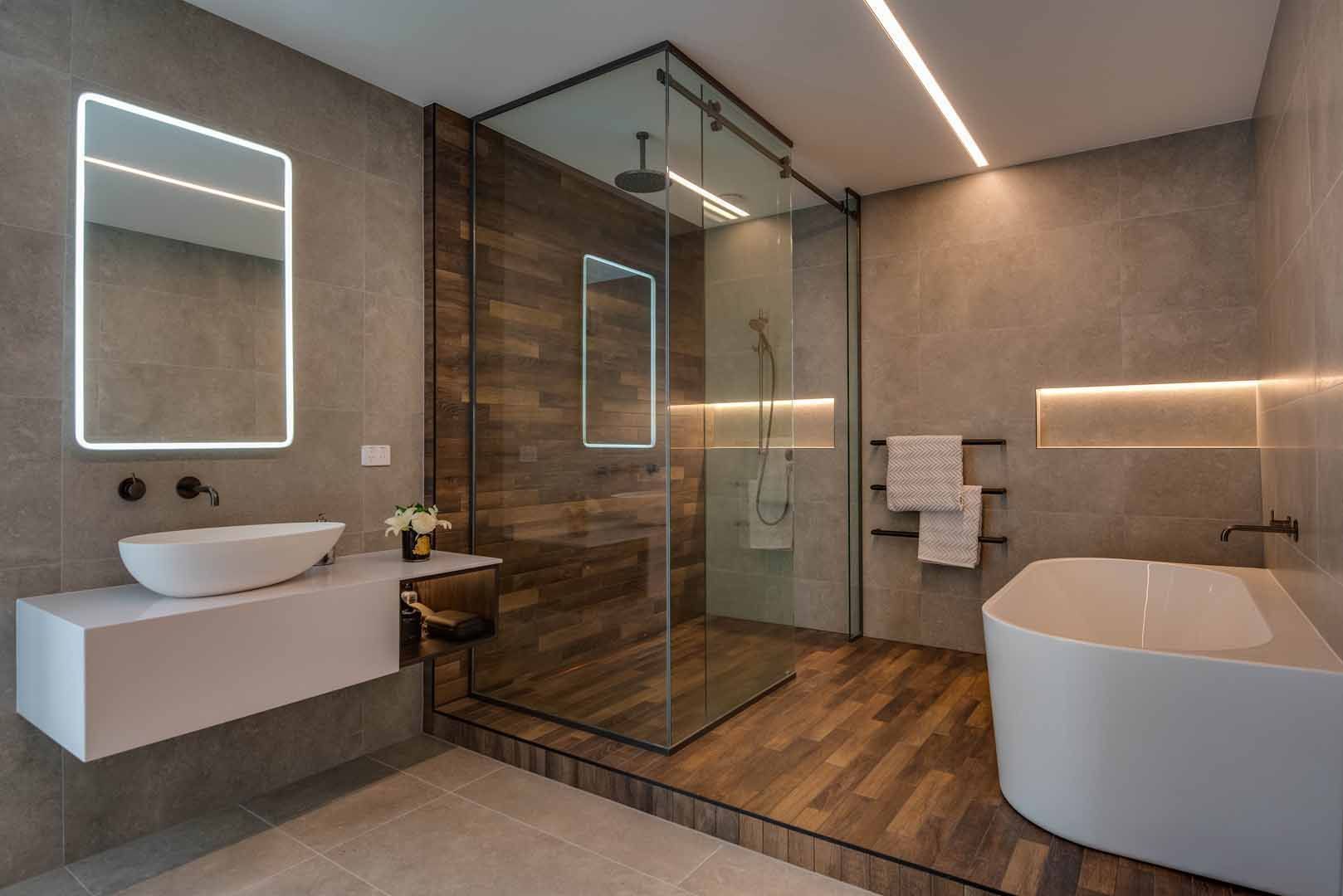 A bathroom with a walk in shower , sink , and bathtub.