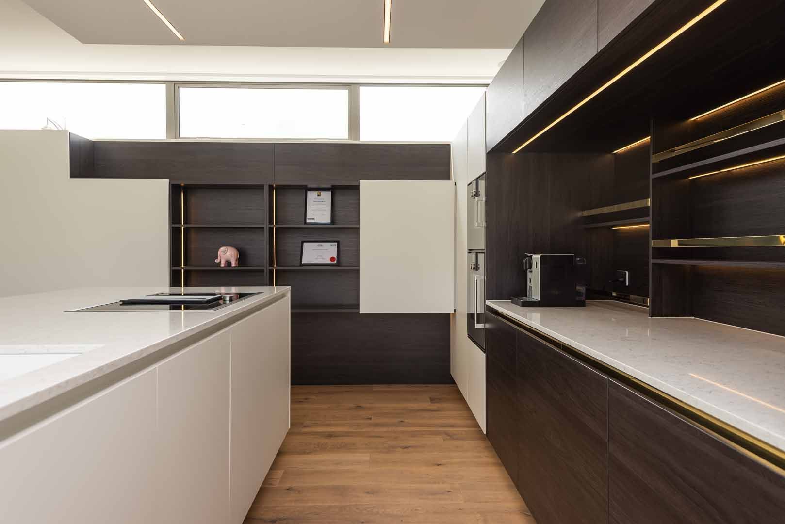 A kitchen with a large island and a stove top oven.