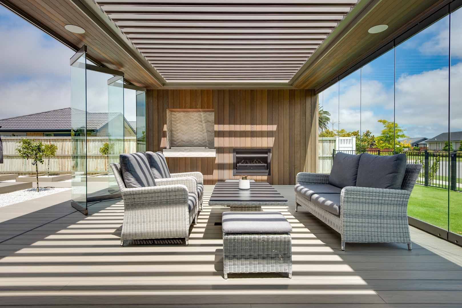 A living room with a couch , chairs , table and fireplace.