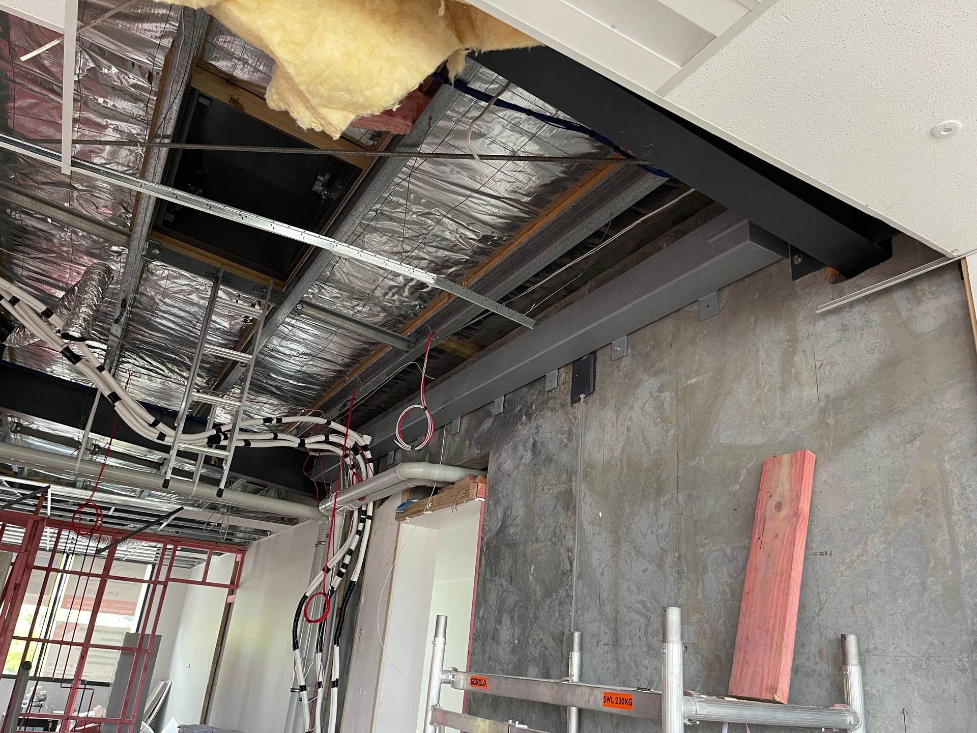 A room with a ladder and a piece of wood in it