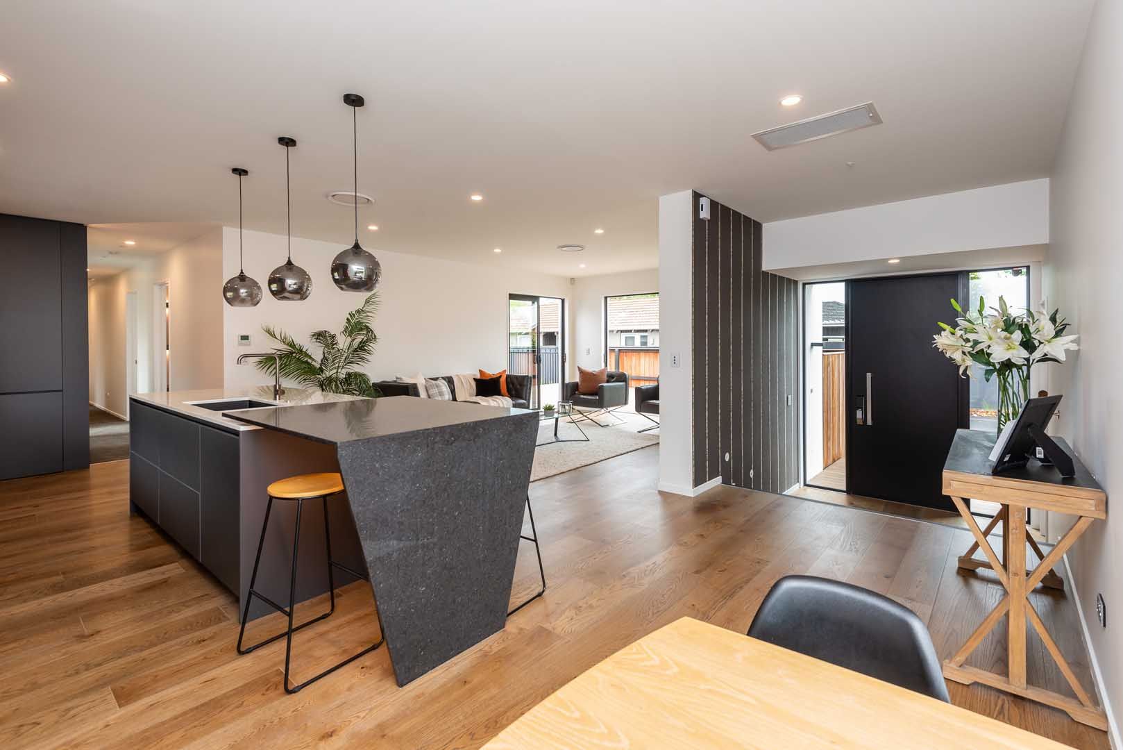 a kitchen and dining area with a black door