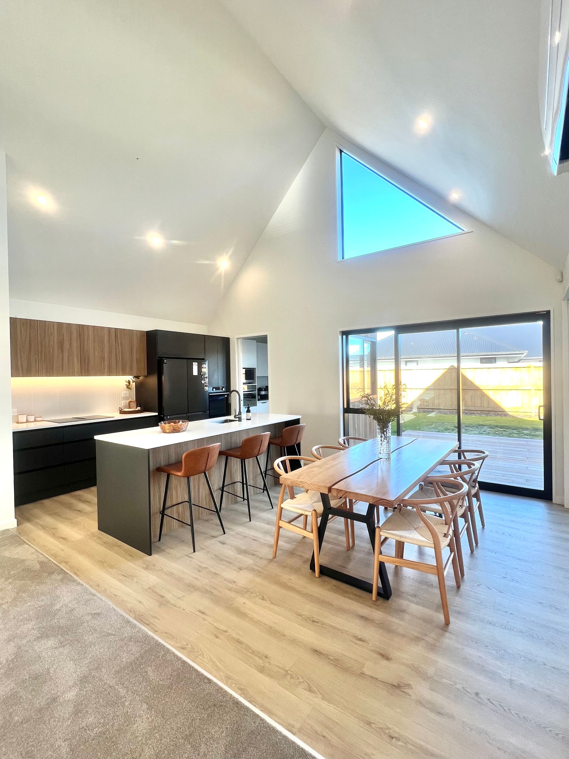 There is a large table and chairs in the middle of the room.