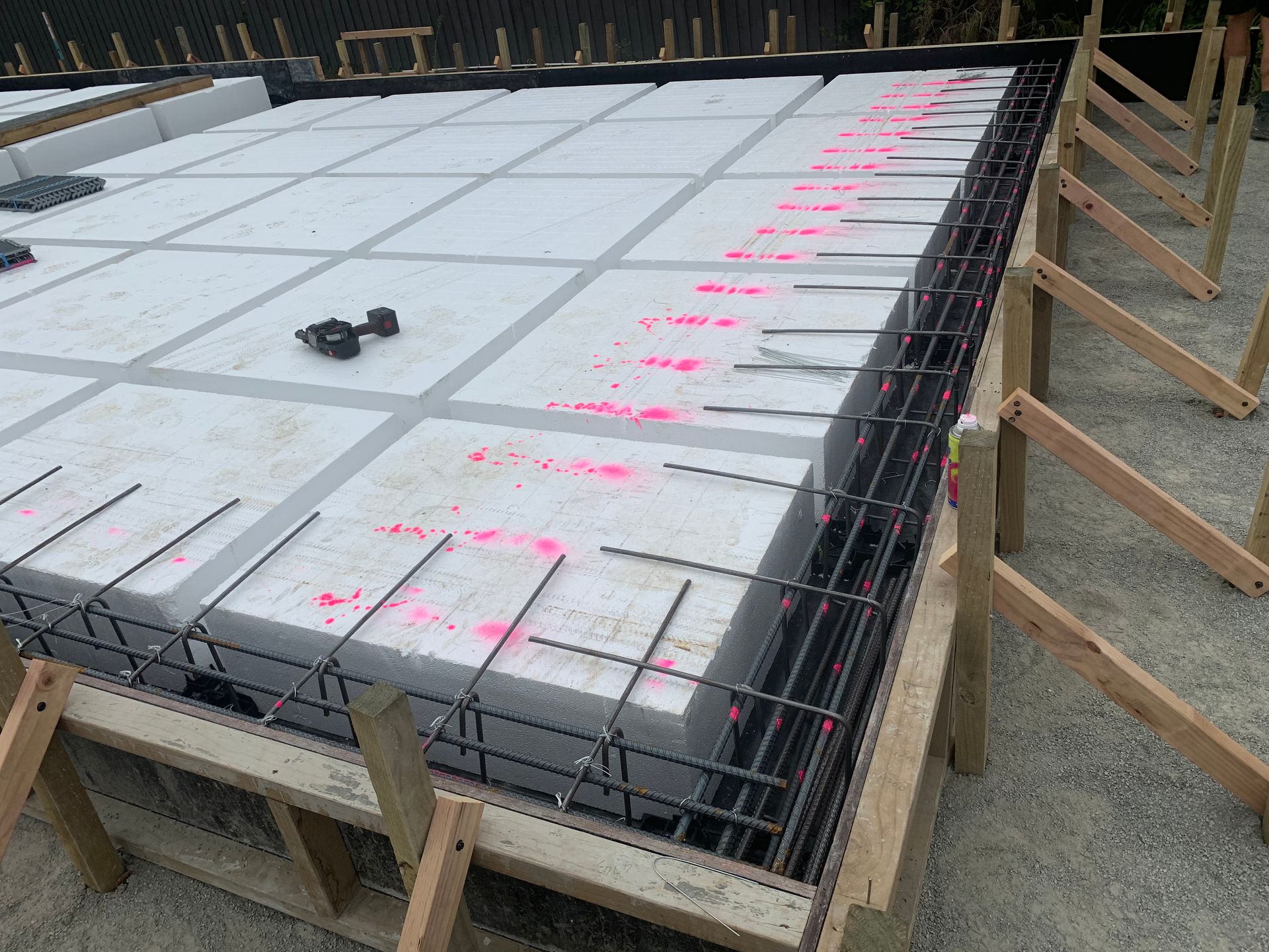 A concrete slab is being built on a construction site.