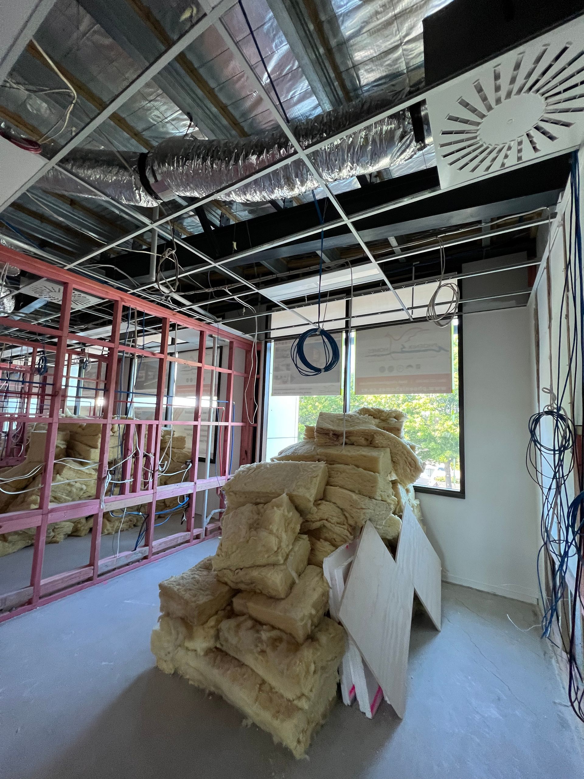 A room with a lot of bags of insulation on the floor.