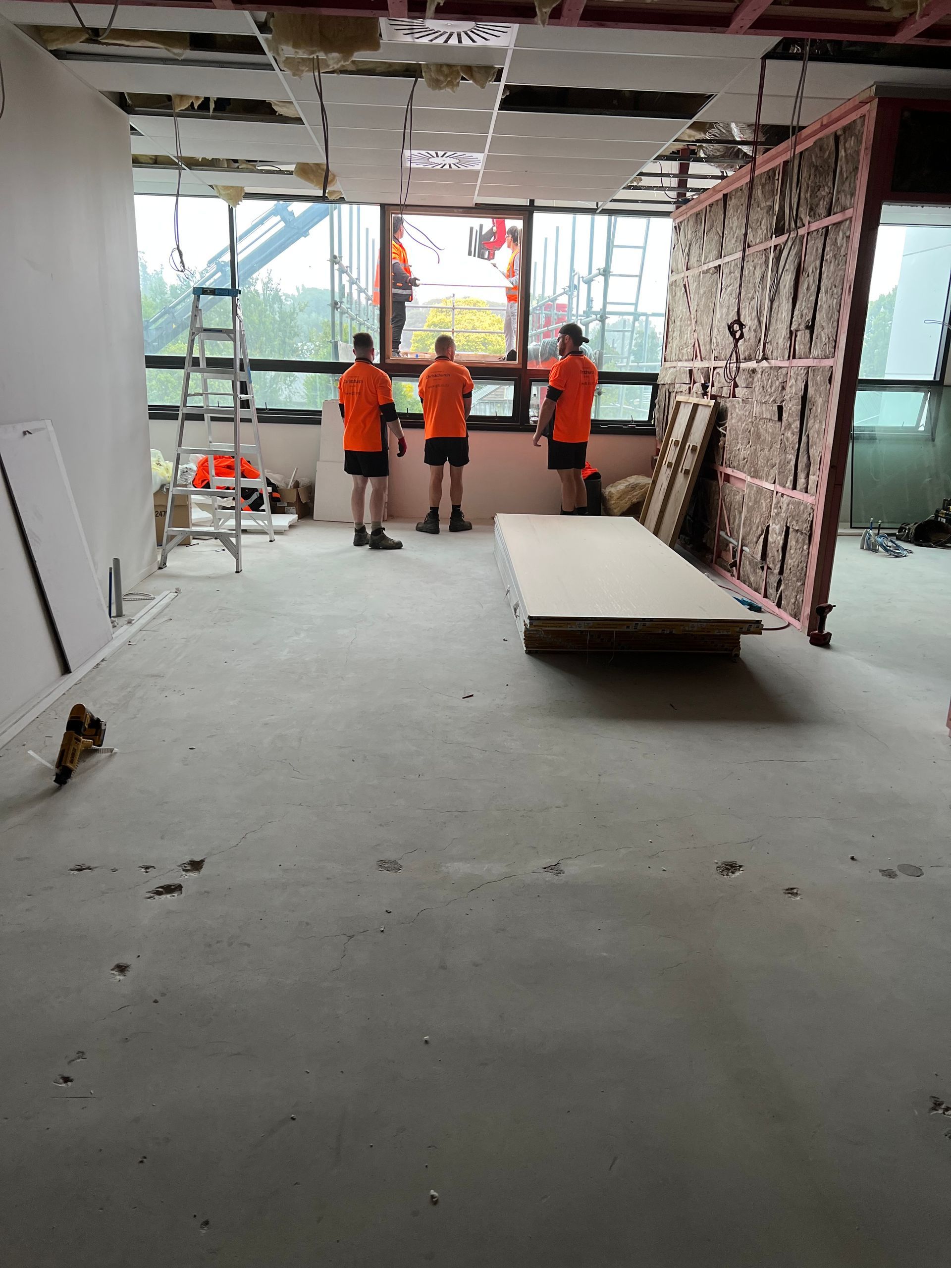 A group of construction workers are working on a building