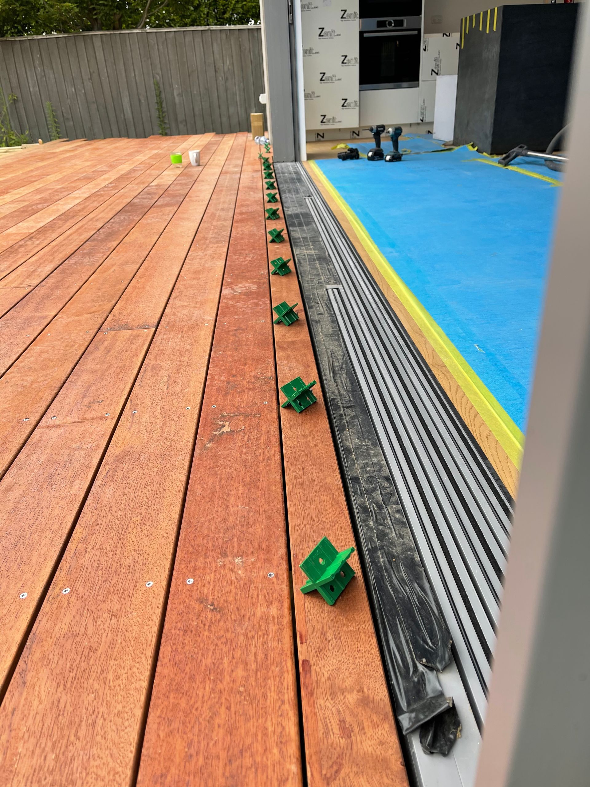 A wooden deck with green clips on it