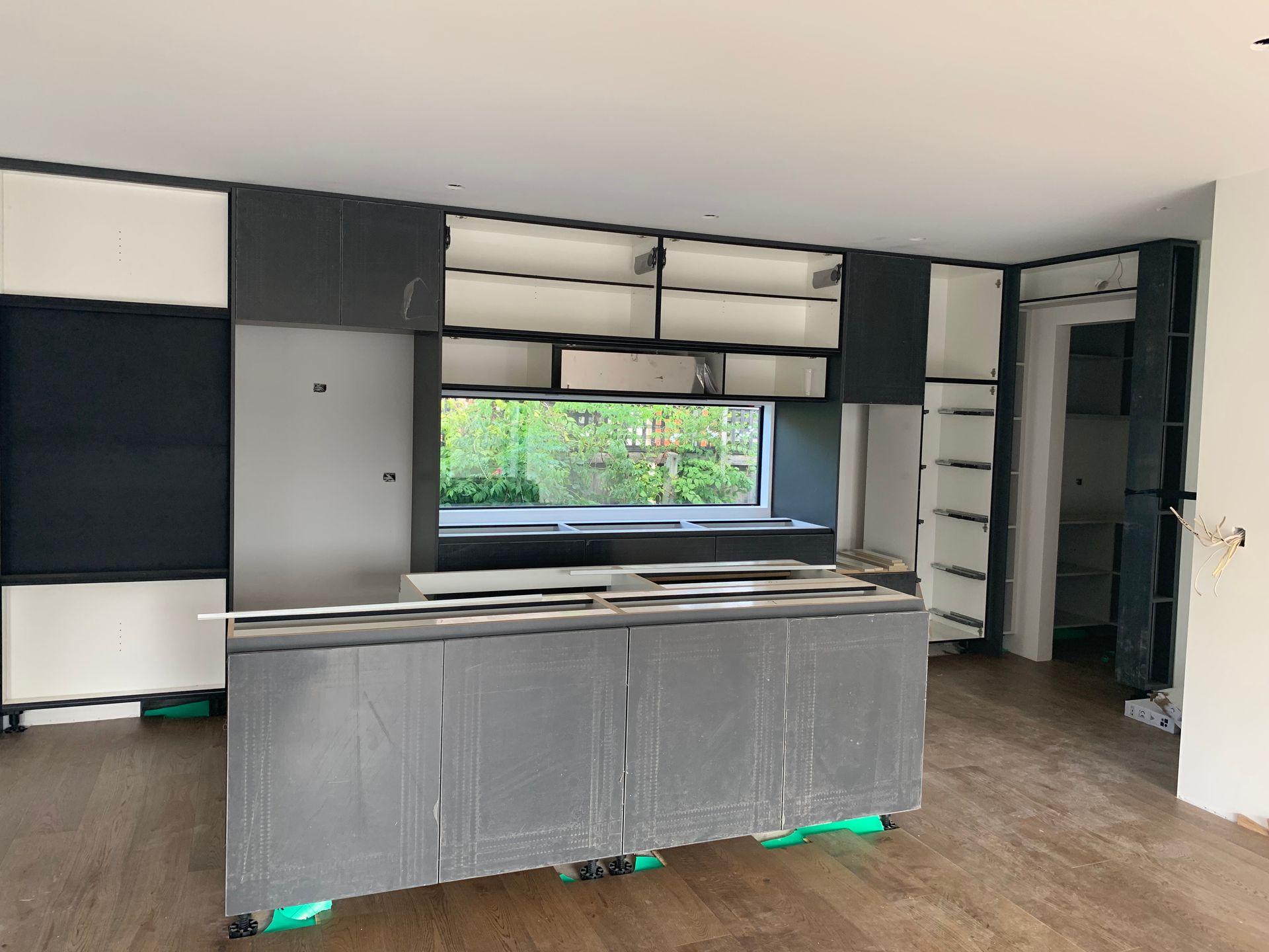 A kitchen with a lot of cabinets and a window