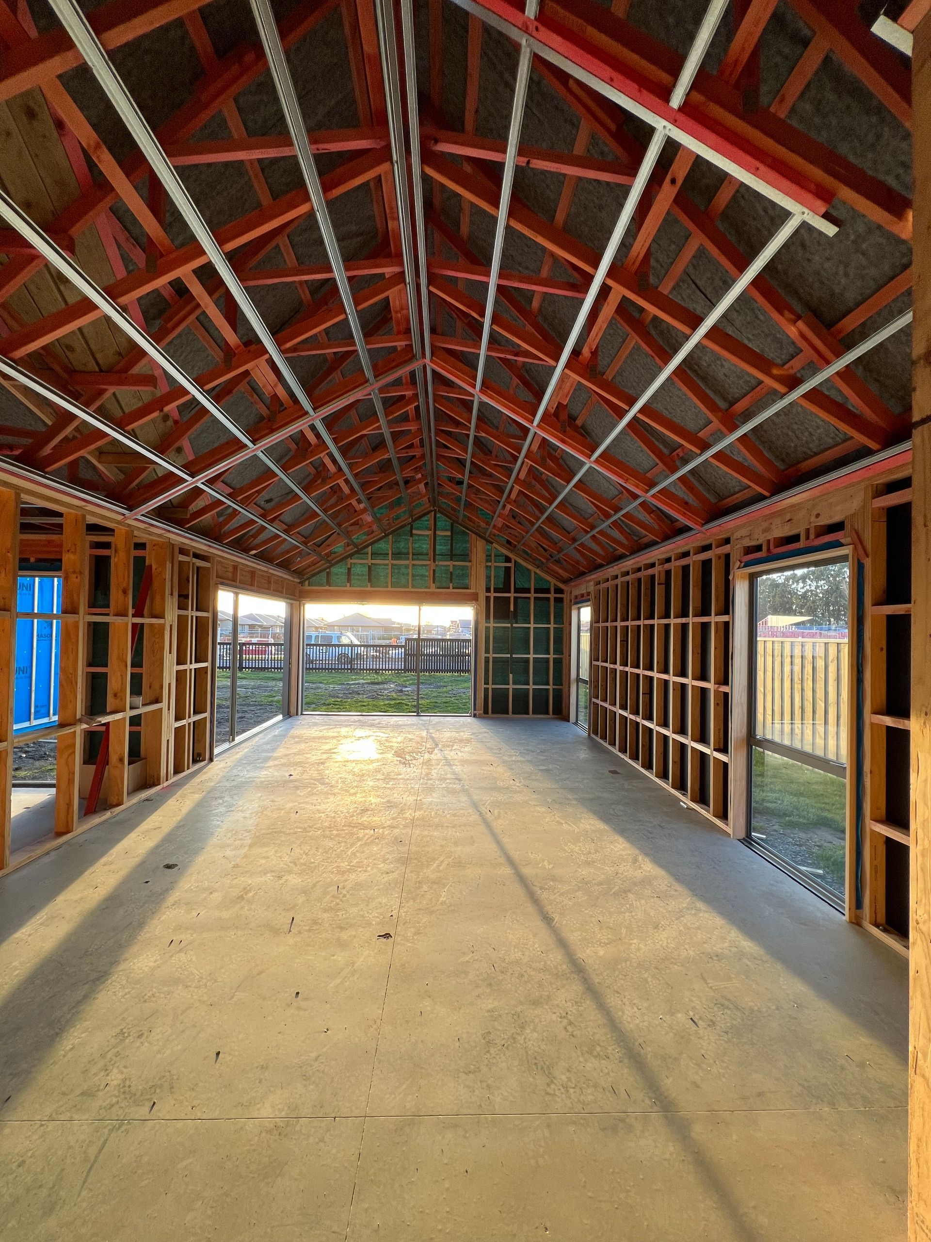 The inside of a building under construction with a red roof
