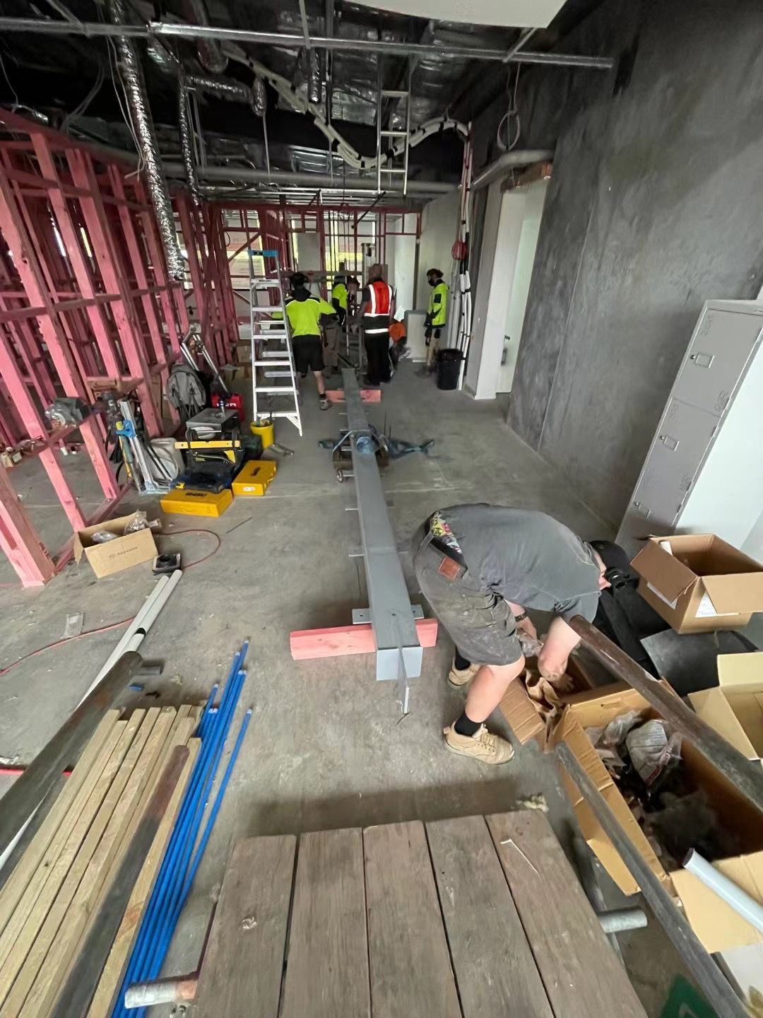 A group of construction workers are working on a building under construction.