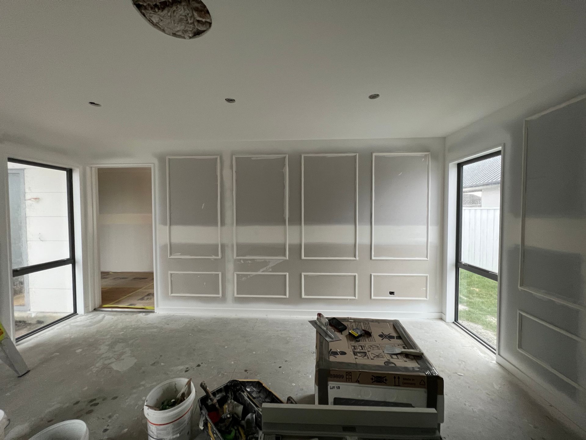 A room with a lot of windows and a table in it