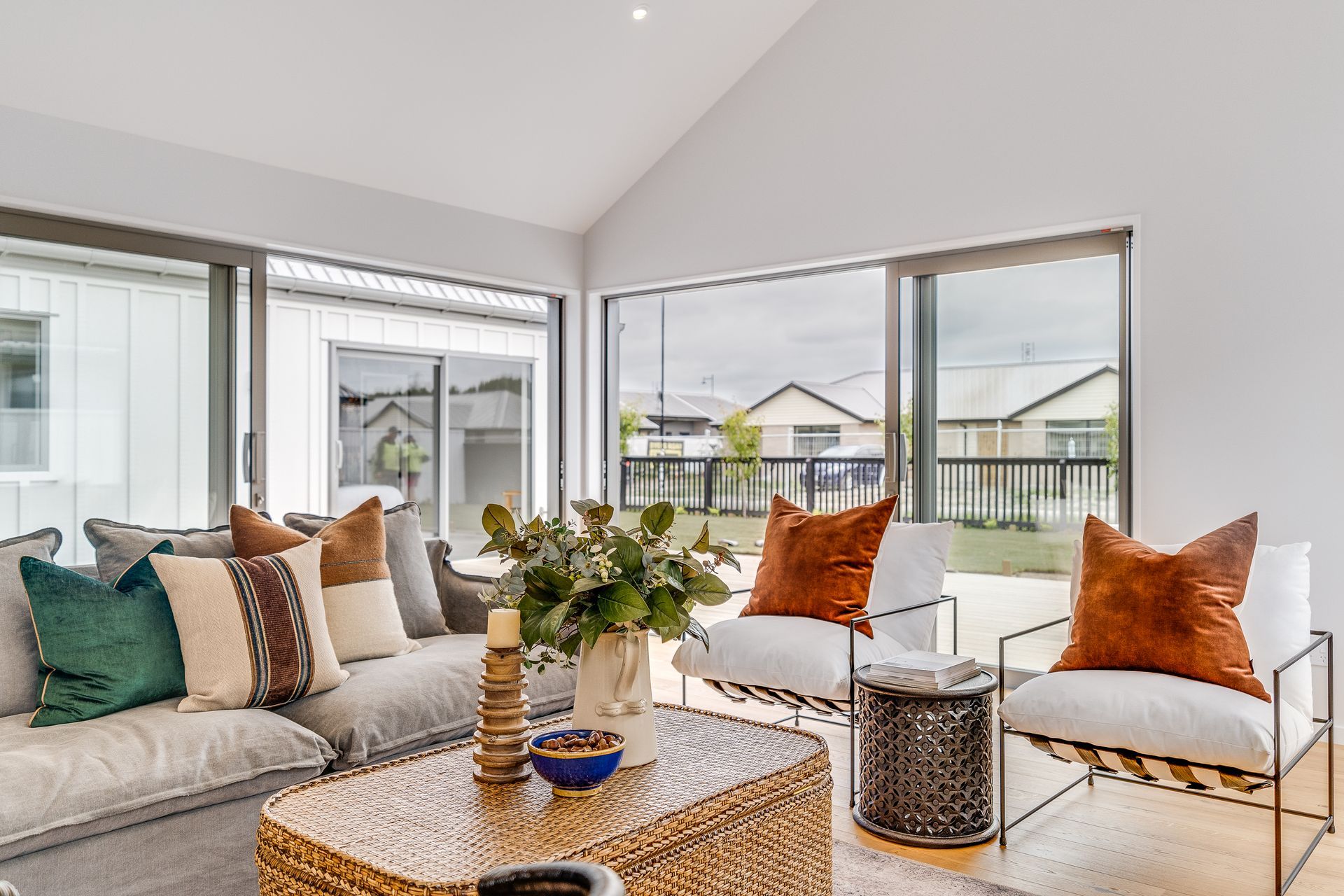 A living room with a couch , chairs and a coffee table.
