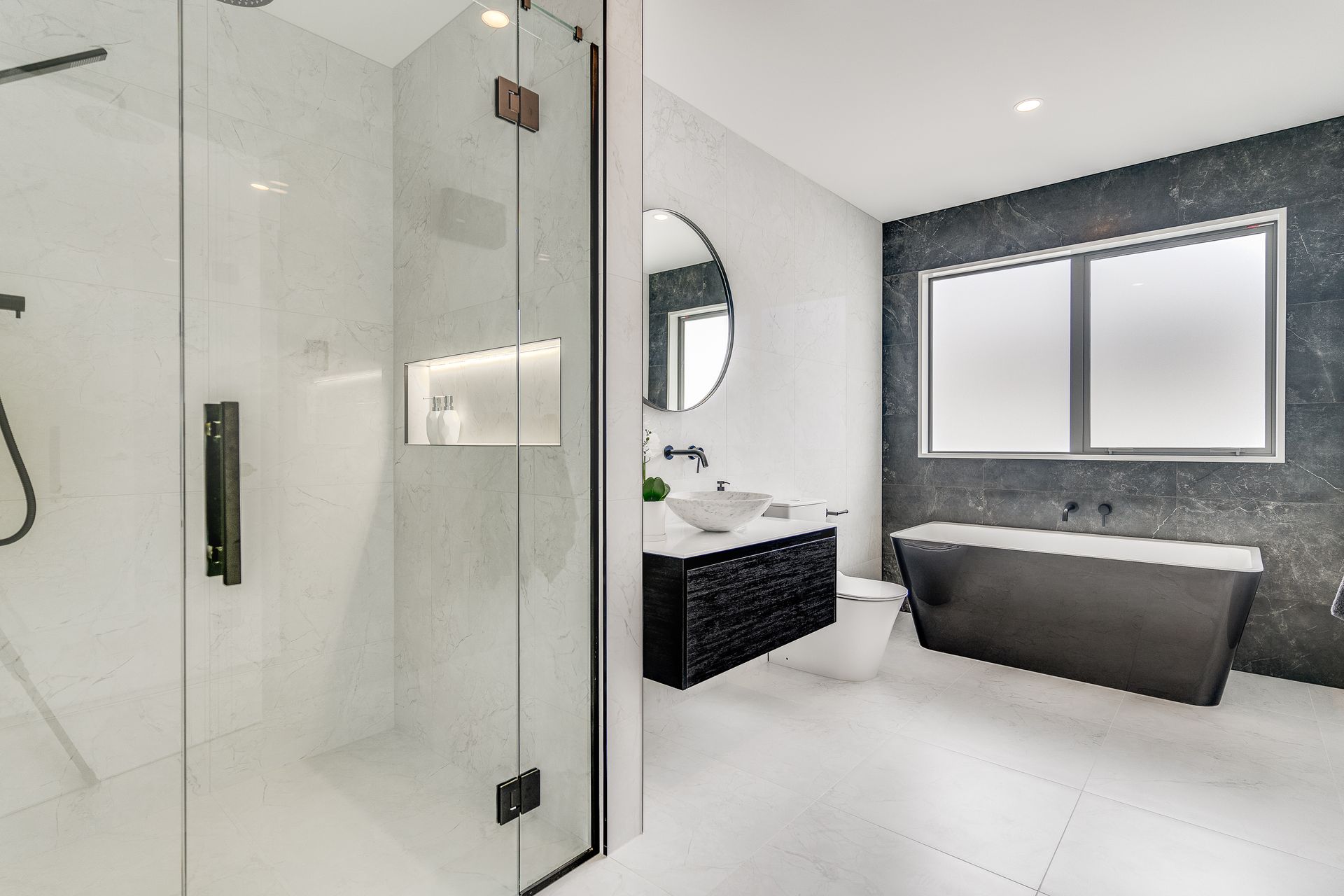 A bathroom with a tub , sink , toilet and shower.