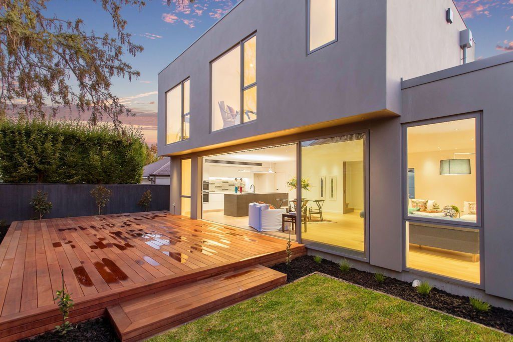 A large house with a large deck in front of it.