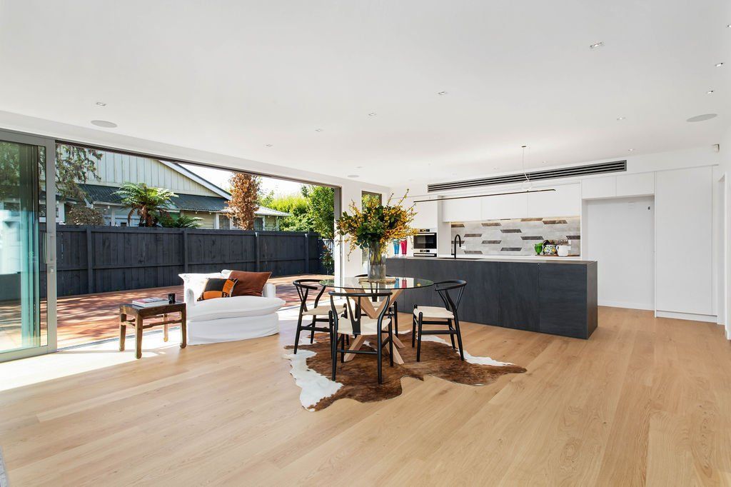 A living room with a table and chairs in it