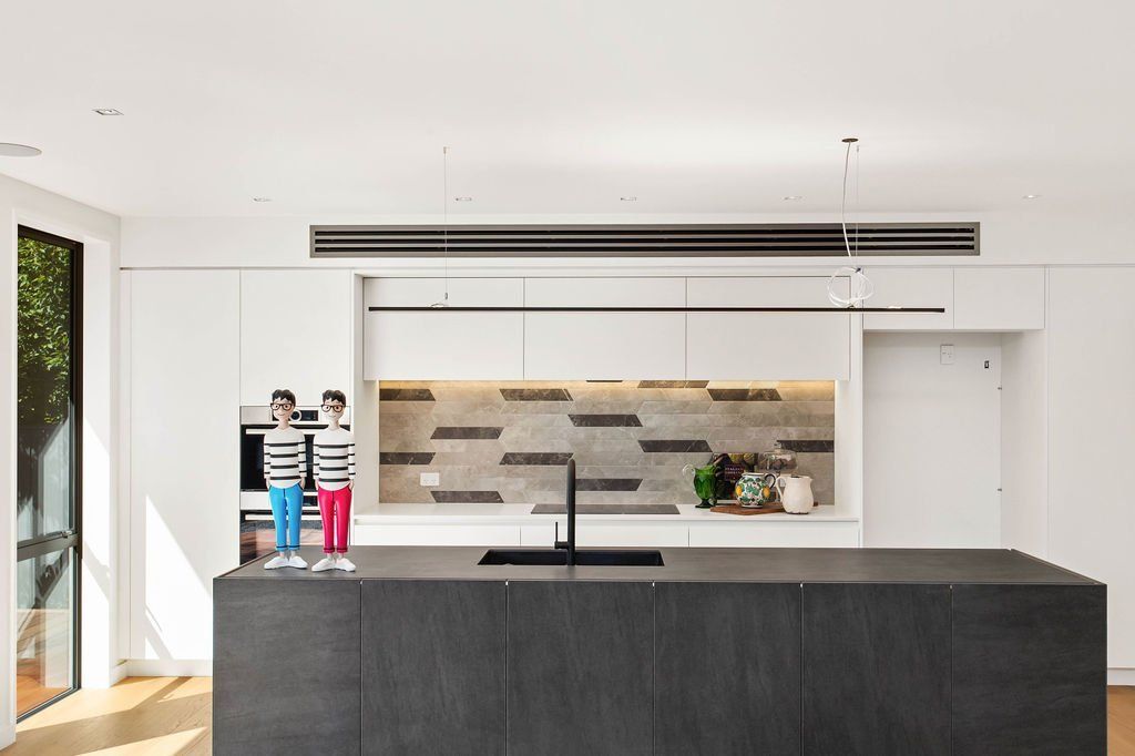 A kitchen with a large island and two figurines on it